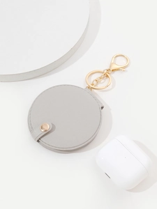 Detail of round gray PU leather mirror keychain with gold snap and lobster clasp