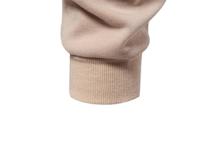 Detail of ribbed knit cuffs on men's beige crewneck sweatshirt with soft fabric texture