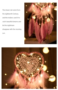 Detail of pink heart dream catcher featuring intricate lace mesh and warm LED lights