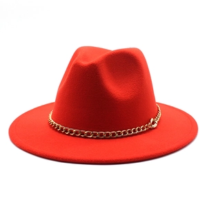 Close-up of red wide brim fedora hat featuring a stylish gold metal chain decoration