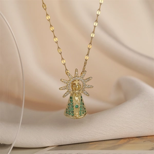 Macro detail of gold plated crown necklace with green and white crystals on silk