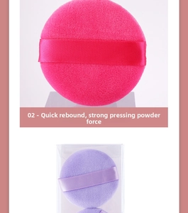 Close-up of soft rose and purple powder puffs with ribbons and clear storage box
