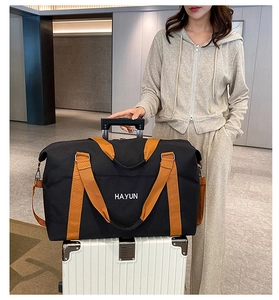 Detail of multi-functional travel bag with HAYUN logo attached to a trolley suitcase