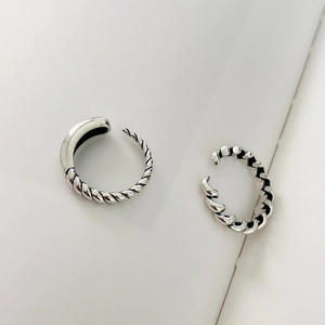 Close-up of minimalist 925 silver rings featuring twisted rope texture and polished finish