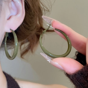 Detail of dark olive green round hoop earrings with smooth glossy lacquer finish