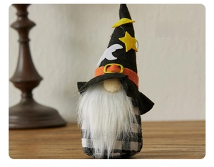 Detail of Halloween gnome with moon stars hat and buffalo plaid body on wood surface