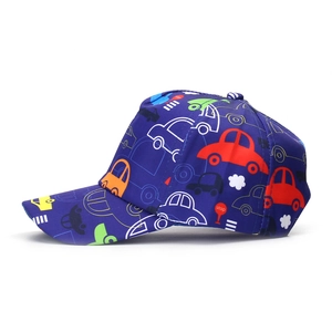 Détail d'une casquette enfant avec motifs de voitures colorées sur tissu bleu marine