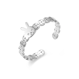 Close-up of adjustable silver rabbit ring with ancient coin pattern on a white base