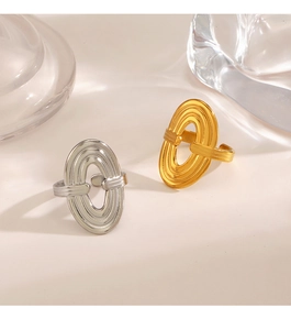 Close-up of gold and silver layered oval rings with high polished metallic finish