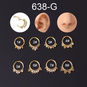 Close-up of gold stainless steel daith rings with clear zircon in eight different styles