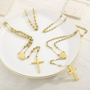 Minimalist gold beaded cross necklace with religious medallion in polished titanium steel