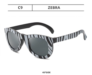 Detailed 45-degree view of zebra pattern kids party glasses with dark lenses