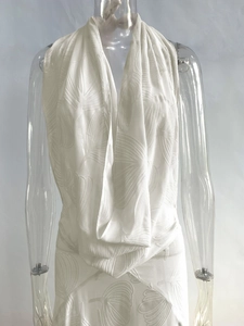Detail of white deep V-neck beach dress with elegant floral jacquard texture fabrics