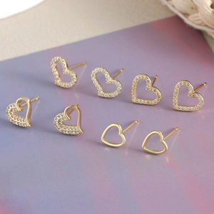 Elegant gold heart earrings with zircon inlay displayed in a four-pair jewelry set