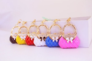 Detailed row of mini handbag keychains with rhinestones and bows in six vibrant colors