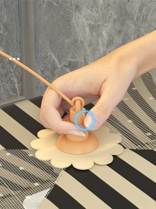 Detail of the orange push-button mechanism for umbrella-style folding food cover