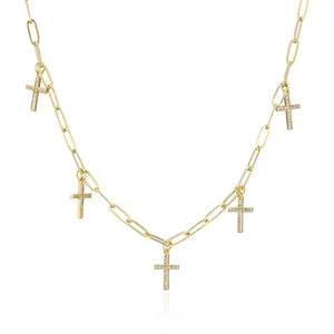 Detail of gold paperclip chain necklace with sparkling zircon cross pendants