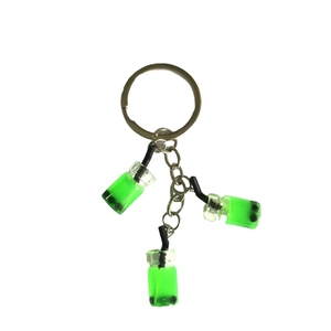 Creative bubble tea keychain featuring mini resin green milk tea cups on a white background