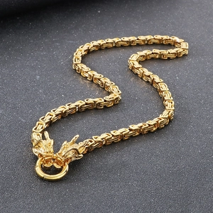 Detailed view of dual golden dragon head closures on a Byzantine imperial steel chain