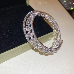 Macro shot of silver triple-layered spiral bracelet encrusted with sparkling cubic zirconia