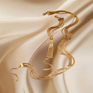 Layered gold stainless steel tassel bracelet with lobster clasp on elegant satin fabric