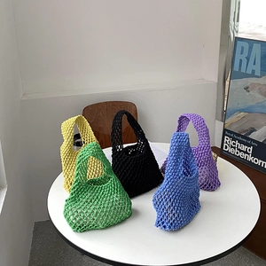 Detail of colorful cotton rope woven tote bags in yellow green black blue and purple colors