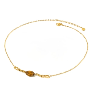 Detail of gold-plated stainless steel necklace with oval tiger eye stone on white background