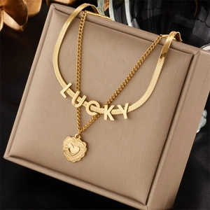Golden double layer titanium necklace with LUCKY letter and heart pendant on jewelry display
