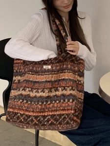 Retro multi-color knitted tote bag with jacquard pattern worn by model in a cafe