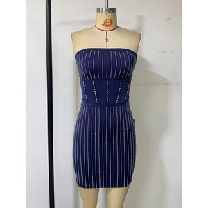 Detail of navy blue tube dress with vertical silver rhinestone stripes and bodycon fit