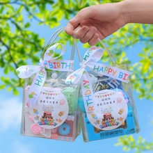 Detailed view of two transparent gift bags with Happy Birthday ribbons and party favors