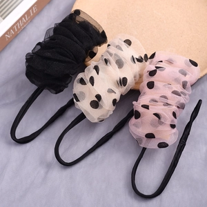 Detailed view of polka dot mesh hair bun makers in pink, beige and black colors.