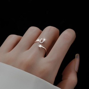 Adjustable silver letter U open ring with sparkling diamond accent on finger