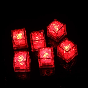 Set of six glowing red LED ice cubes with water sensor feature in a dark background