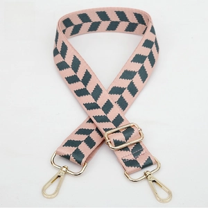 Detail of pink jacquard replacement bag strap with green zigzag pattern and gold hardware