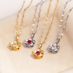 Close-up of rose flower pendant necklaces in gold and silver finish with red crystals