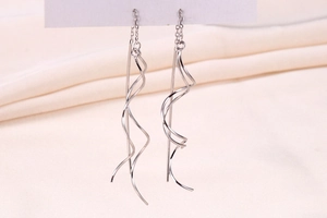 Detailed close-up of S925 sterling silver spiral long threader earrings on white card
