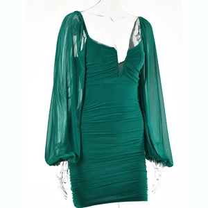 Detail of dark green V-neck dress with ruched bodice and mesh lantern sleeves