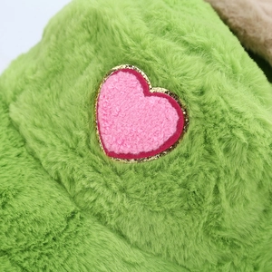 Winter faux fur bucket hat with pink heart patch and gold sequins on green plush fabric
