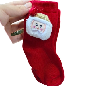 Cute red Christmas socks for children with a 3D Santa Claus plush doll ornament