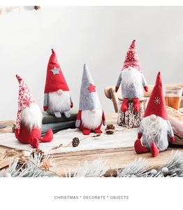Detailed close-up of Christmas gnomes on wooden surface with pine cones and books