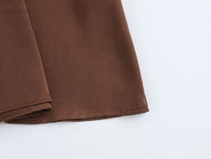 Detail view of neatly stitched hem on a brown faux suede elegant chiffon maxi dress