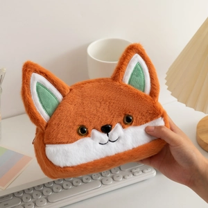 Close-up of orange plush fox pencil case being held, showing soft texture and zip detail