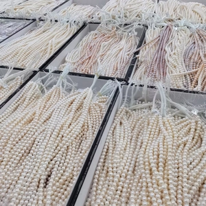 Bulk selection of natural freshwater pearl necklaces in white and pink storage boxes
