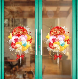Detail view of colorful New Year and Christmas balloon stickers on glass door