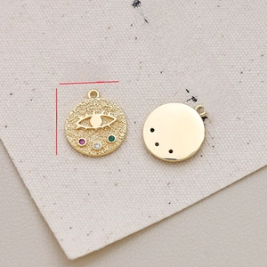 Macro detail of 14mm gold-plated evil eye pendants with colorful zircon inlays