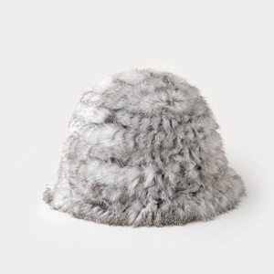 Close-up of thick faux rabbit fur texture on a warm winter bucket hat in grey and white