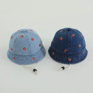 Detail of embroidered strawberry on denim bucket hats with adjustable windproof drawstrings