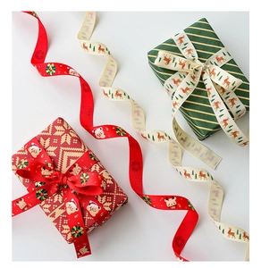 Close-up of festive Christmas ribbons with reindeer and bear patterns on gift boxes