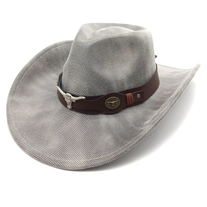Detail of light gray mesh cowboy hat with brown leather band and bull head metal charms